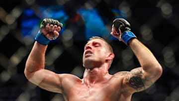 Jul 27, 2019; Edmonton, Alberta, Canada; Krzysztof Jotko (blue gloves) defeats Marc-Andre Barriault (red gloves) during UFC 240 at Rogers Place. Mandatory Credit: Sergei Belski-USA TODAY Sports