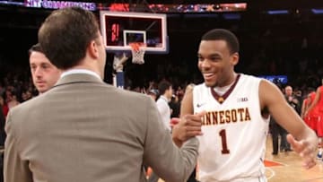 Apr 3, 2014; New York, NY, USA; Minnesota Golden Gophers guard Andre Hollins (1) celebrates with head coach Richard Pitino after defeating the Southern Methodist Mustangs in the 2014 NIT Tournament championship game at Madison Square Garden. The Golden Gophers won 65-63. Mandatory Credit: Adam Hunger-USA TODAY Sports