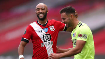 SOUTHAMPTON, ENGLAND - JULY 26: Nathan Redmond of Southampton interacts with George Baldock of Sheffield United during the Premier League match between Southampton FC and Sheffield United at St Mary's Stadium on July 26, 2020 in Southampton, England. Football Stadiums around Europe remain empty due to the Coronavirus Pandemic as Government social distancing laws prohibit fans inside venues resulting in all fixtures being played behind closed doors. (Photo by Naomi Baker/Getty Images)