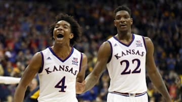 KANSAS CITY, MO - MARCH 10: Devonte' Graham #4 of the Kansas Jayhawks celebrates with Silvio De Sousa #22 after the Jayhawks defeated the West Virginia Mountaineers 81-70 to win the Big 12 Basketball Tournament Championship game at Sprint Center on March 10, 2018 in Kansas City, Missouri. (Photo by Jamie Squire/Getty Images)