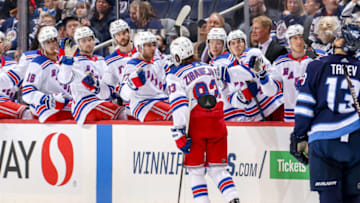 WINNIPEG, MB - FEBRUARY 12: Mika Zibanejad #93 of the New York Rangers celebrates his third period goal against the Winnipeg Jets with teammates at the bench at the Bell MTS Place on February 12, 2019 in Winnipeg, Manitoba, Canada. (Photo by Jonathan Kozub/NHLI via Getty Images)