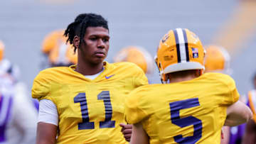 Apr 17, 2021; Baton Rouge, Louisiana, USA; LSU Tigers quarterback TJ Finley (11) warms up with LSU Tigers quarterback Garrett Nussmeier (5) on the sidelines during the first half of the annual Purple and White spring game at Tiger Stadium. Mandatory Credit: Stephen Lew-USA TODAY Sports