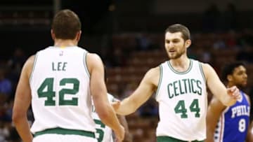 Oct 23, 2015; Manchester, NH, USA; Boston Celtics center Tyler Zeller (44) and forward David Lee (42) celebrate against the Philadelphia 76ers during the first half at Verizon Wireless Arena. Mandatory Credit: Mark L. Baer-USA TODAY Sports