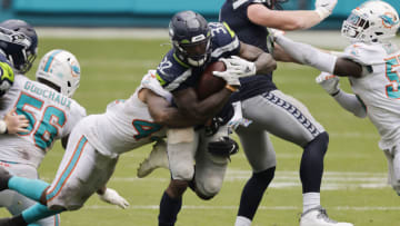 MIAMI GARDENS, FLORIDA - OCTOBER 04: Chris Carson #32 of the Seattle Seahawks runs with the ball against the Miami Dolphins during the second half at Hard Rock Stadium on October 04, 2020 in Miami Gardens, Florida. (Photo by Michael Reaves/Getty Images)
