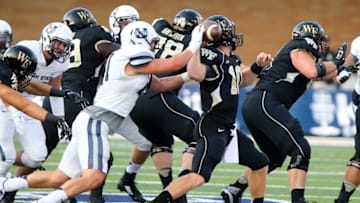 Sep 13, 2014; Logan, UT, USA; Utah State Aggies linebacker Nick Vigil (41) hits the ball out of Wake Forest Demon Deacons quarterback John Wolford (10) hand and causes a fumble during the second quarter at Romney Stadium. Mandatory Credit: Chris Nicoll-USA TODAY Sports