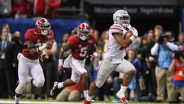 Jan 1, 2015; New Orleans, LA, USA; Ohio State Buckeyes running back Ezekiel Elliott (15) pulls away from Alabama Crimson Tide defensive back Nick Perry (27) and defensive back Cyrus Jones (5)enroute to a 85-yard touchdown in the fourth quarter of the 2015 Sugar Bowl at Mercedes-Benz Superdome. Mandatory Credit: Crystal LoGiudice-USA TODAY Sports