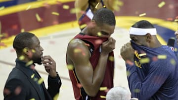 Feb 11, 2015; Cleveland, OH, USA; Miami Heat guard Dwyane Wade (left), center Chris Bosh (center) and Cleveland Cavaliers forward LeBron James (23) talks after Cleveland