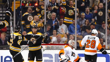 Oct 21, 2015; Boston, MA, USA; Boston Bruins center Chris Kelly (23) celebrates his shorthanded goal with left wing Loui Eriksson (21) as Philadelphia Flyers goalie Steve Mason (35) and center Claude Giroux (28) look away during the second period at TD Garden. Mandatory Credit: Winslow Townson-USA TODAY Sports