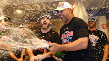 NEW YORK, NEW YORK - OCTOBER 09: Alex Cora #20 of the Boston Red Sox celebrates in the locker room with his team after defeating the New York Yankees to win Game Four American League Division Series by a score of 4-3 at Yankee Stadium on October 09, 2018 in the Bronx borough of New York City. (Photo by Elsa/Getty Images)