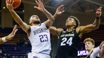 Jan 27, 2022; Seattle, Washington, USA; Washington Huskies guard Terrell Brown Jr. (23) shoots a layup against Colorado Buffaloes guard Elijah Parquet (24) during the first half at Alaska Airlines Arena at Hec Edmundson Pavilion. Mandatory Credit: Joe Nicholson-USA TODAY Sports