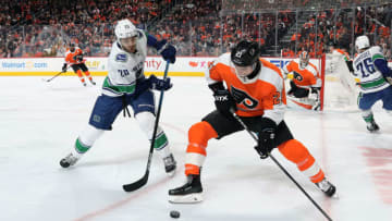 PHILADELPHIA, PA - FEBRUARY 04: Scott Laughton #21 of the Philadelphia Flyers battles for the puck against Brandon Sutter #20 of the Vancouver Canucks on February 4, 2019 at the Wells Fargo Center in Philadelphia, Pennsylvania. (Photo by Len Redkoles/NHLI via Getty Images)