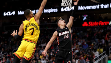 Jan 12, 2022; Atlanta, Georgia, USA; Miami Heat guard Tyler Herro (14) shoots against Atlanta Hawks guard Timothe Luwawu-Cabarrot (7) during the second quarter at State Farm Arena. Mandatory Credit: Jason Getz-USA TODAY Sports