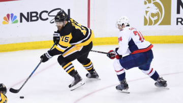 PITTSBURGH, PA - MAY 07: Pittsburgh Penguins center Riley Sheahan (15) handles the puck while Washington Capitals Defenseman John Carlson (74) defends during the overtime period. The Washington Capitals went on win 2-1 in the overtime period against the Pittsburgh Penguins in Game Six of the Eastern Conference Second Round during the 2018 NHL Stanley Cup Playoffs on May 7, 2018, at PPG Paints Arena in Pittsburgh, PA. The Capitals won the series 4-2 and advance to the Eastern Conference Final. (Photo by Jeanine Leech/Icon Sportswire via Getty Images)