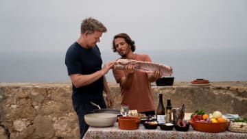 Portugal - Gordon Ramsay (L) and Chef Kiko Martins with a cut of pork during the final cook. (Credit: National Geographic/Justin Mandel)