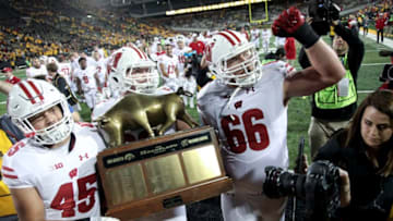 IOWA CITY, IOWA- SEPTEMBER 22: Fullback Alec Ingold #45, offensive lineman Michael Dieter #63 and offensive lineman Beau Benzschawel #66 of the Wisconsin Badgers carry the Heartland Trophy off the field after defeating the Iowa Hawkeyes, on September 22, 2018 at Kinnick Stadium, in Iowa City, Iowa. (Photo by Matthew Holst/Getty Images)