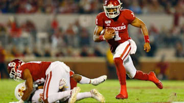 NORMAN, OK - NOVEMBER 9: Quarterback Jalen Hurts #1 of the Oklahoma Sooners runs for a nine-yard gain to set up a touchdown with the help of a block by fullback Brayden Willis #81 against defensive back Anthony Johnson #26 of the Iowa State Cyclones in the second quarter on November 9, 2019 at Gaylord Family Oklahoma Memorial Stadium in Norman, Oklahoma. OU held on to win 42-41. (Photo by Brian Bahr/Getty Images)