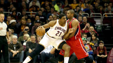 CLEVELAND, OH - DECEMBER 26: Andrew Bynum #21 of the Cleveland Cavaliers handles the ball against Al Horford #15 of the Atlanta Hawks in the first half at Quicken Loans Arena on December 26, 2013 in Cleveland, Ohio. NOTE TO USER: User expressly acknowledges and agrees that, by downloading and/or using this photograph, user is consenting to the terms and conditions of the Getty Images License Agreement. (Photo by Mike Lawrie/Getty Images)