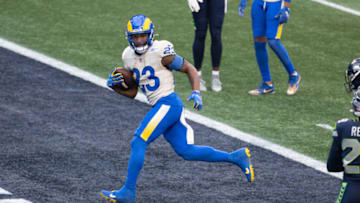 Jan 9, 2021; Seattle, Washington, USA; Los Angeles Rams running back Cam Akers (23) runs in for a touchdown against the Seattle Seahawks during the first half at Lumen Field. Mandatory Credit: Steven Bisig-USA TODAY Sports