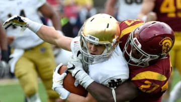 LOS ANGELES, CA - NOVEMBER 26: Ajene Harris #27 of the USC Trojans tackles Chris Finke #10 of the Notre Dame Fighting Irish in the third quarter at Los Angeles Memorial Coliseum on November 26, 2016 in Los Angeles, California. (Photo by Lisa Blumenfeld/Getty Images)