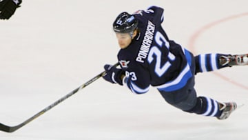 WINNIPEG, CANADA - FEBRUARY 12: Alexei Ponikarovsky #23 of the Winnipeg Jets keeps an eye on the puck as he flies through the air during first period action against the Philadelphia Flyers at the MTS Centre on February 12, 2013 in Winnipeg, Manitoba, Canada. The Flyers defeated the Jets 3-2. (Photo by Travis Golby/NHLI via Getty Images)