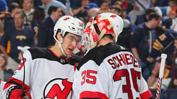 BUFFALO, NY - OCTOBER 9: Nico Hischier #13 and Cory Schneider #35 of the New Jersey Devils celebrate their 6-2 victory over the Buffalo Sabres in an NHL game on October 9, 2017 at KeyBank Center in Buffalo, New York. (Photo by Bill Wippert/NHLI via Getty Images)