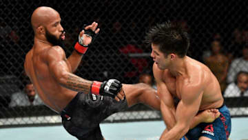LOS ANGELES, CA - AUGUST 04: (L-R) Demetrious Johnson kicks Henry Cejudo in their UFC flyweight championship fight during the UFC 227 event inside Staples Center on August 4, 2018 in Los Angeles, California. (Photo by Jeff Bottari/Zuffa LLC/Zuffa LLC via Getty Images)