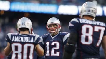 Jan 16, 2016; Foxborough, MA, USA; New England Patriots quarterback Tom Brady (12), wide receiver Danny Amendola (80), and tight end Rob Gronkowski (87) look on prior to the AFC Divisional round playoff game against the Kansas City Chiefs at Gillette Stadium. Mandatory Credit: David Butler II-USA TODAY Sports