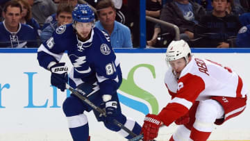 Apr 15, 2016; Tampa, FL, USA; Tampa Bay Lightning right wing Nikita Kucherov (86) passes the puck as Detroit Red Wings left wing Justin Abdelkader (8) defends during the third period of the game two of the first round of the 2016 Stanley Cup Playoffs at Amalie Arena. Tampa Bay Lightning defeated the Detroit Red Wings 5-2. Mandatory Credit: Kim Klement-USA TODAY Sports