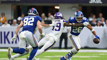 Dec 24, 2022; Minneapolis, Minnesota, USA; New York Giants running back Saquon Barkley (26) breaks a tackle against the Minnesota Vikings during the fourth quarter at U.S. Bank Stadium. Mandatory Credit: Matt Krohn-USA TODAY Sports