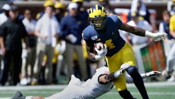ANN ARBOR, MI - SEPTEMBER 7: Wide Receiver Nico Collins #4 of the Michigan Wolverines gets tackled by defensive back Jaylon McClinton #7 of the Army Black Knights during the second half at Michigan Stadium on September 7, 2019 in Ann Arbor, Michigan. (Photo by Duane Burleson/Getty Images)