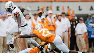 KNOXVILLE, TN - SEPTEMBER 15: Quarterback Kai Locksley #1 of the UTEP Miners tries to avoid a tackle from Defensive back Micah Abernathy #22 of the Tennessee Volunteers and Linebacker Jonathan Kongbo #99 of the Tennessee Volunteers during the second half of the game between the UTEP Miners and Tennessee Volunteers at Neyland Stadium on September 15, 2018 in Knoxville, Tennessee. Tennessee won the game 24-0. (Photo by Donald Page/Getty Images)