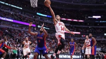 Apr 11, 2014; Chicago, IL, USA; Chicago Bulls guard D.J. Augustin (14) scores over Detroit Pistons center Andre Drummond (0) during the second half at the United Center. Chicago won 106-98. Mandatory Credit: Dennis Wierzbicki-USA TODAY Sports