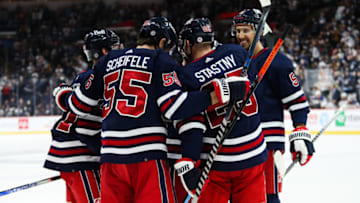 Dec 19, 2021; Winnipeg, Manitoba, CAN; Winnipeg Jets forward Mark Scheifele (55) is congratulated by teammates after scoring a goal against the St. Louis Blues during the second period at Canada Life Centre. Mandatory Credit: Terrence Lee-USA TODAY Sports