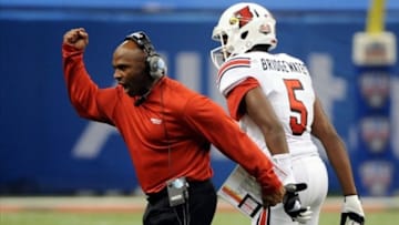 Jan 2, 2013; New Orleans, LA, USA; Louisville Cardinals head coach Charlie Strong and quarterback Teddy Bridgewater (5) celebrate a third quarter touchdown against the Florida Gators during the third quarter of the Sugar Bowl at the Mercedes-Benz Superdome. Mandatory Credit: Chuck Cook-USA TODAY Sports
