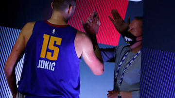 LAKE BUENA VISTA, FLORIDA - AUGUST 30: Nikola Jokic #15 of the Denver Nuggets high-fives staff members as he leaves the court following a team win against the Utah Jazz in Game Six of the Western Conference First Round during the 2020 NBA Playoffs at AdventHealth Arena at ESPN Wide World Of Sports Complex on August 30, 2020 in Lake Buena Vista, Florida. NOTE TO USER: User expressly acknowledges and agrees that, by downloading and or using this photograph, User is consenting to the terms and conditions of the Getty Images License Agreement. (Photo by Kevin C. Cox/Getty Images)