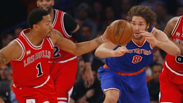 Mar 24, 2016; New York, NY, USA; New York Knicks center Robin Lopez (8) watches Chicago Bulls guard Derrick Rose (1) grab a looses ball during first half at Madison Square Garden. Mandatory Credit: Noah K. Murray-USA TODAY Sports