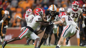 Tennessee wide receiver Cedric Tillman (4) is tackled by Georgia defensive back Derion Kendrick (11) and Georgia defensive back Dan Jackson (47) during an SEC football homecoming game between the Tennessee Volunteers and the Georgia Bulldogs in Neyland Stadium in Knoxville on Saturday, Nov. 13, 2021.Tennesseegeorgia1113 2115