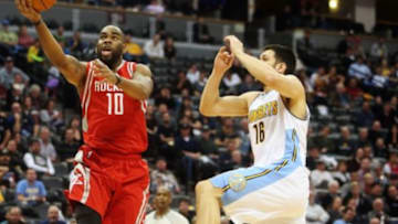 Dec 14, 2015; Denver, CO, USA; Houston Rockets forward Marcus Thornton (10) shoots the ball against Denver Nuggets forward Kostas Papanikolaou (16) during the second half at Pepsi Center. The Nuggets won 114-108. Mandatory Credit: Chris Humphreys-USA TODAY Sports