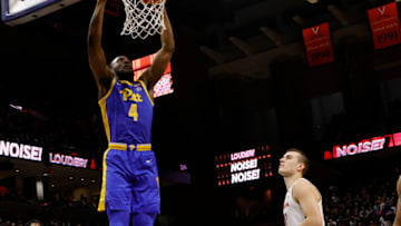 Dec 3, 2021; Charlottesville, Virginia, USA;Pittsburgh Panthers forward Daniel Oladapo (4) dunk the ball as Virginia Cavaliers guard Taine Murray (10) looks on during the first half at John Paul Jones Arena. Mandatory Credit: Geoff Burke-USA TODAY Sports