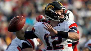 MOBILE, AL - JANUARY 29: Quarterback Ricky Stanzi #12 of the North Team passes over South Team defenders during second quarter of the Under Armour Senior Bowl on January 29, 2011 at Ladd Peebles Stadium in Mobile, Alabama. (Photo by Sean Gardner/Getty Images for Under Armour)