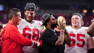 Jan 1, 2016; Glendale, AZ, USA; Ohio State Buckeyes head coach Urban Meyer celebrates with offensive lineman Taylor Decker (68), running back Ezekiel Elliott (15) and offensive lineman Pat Elflein (65) after beating the Notre Dame Fighting Irish 44-28 in the 2016 Fiesta Bowl at University of Phoenix Stadium. Mandatory Credit: Matt Kartozian-USA TODAY Sports