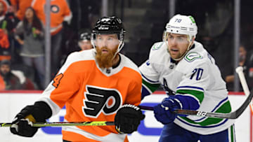 Oct 15, 2021; Philadelphia, Pennsylvania, USA; Philadelphia Flyers defenseman Ryan Ellis (94) and Vancouver Canucks left wing Tanner Pearson (70) battle at Wells Fargo Center. Mandatory Credit: Eric Hartline-USA TODAY Sports