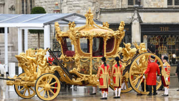 LONDON, ENGLAND - MAY 06: The Gold State Coach built in 1760 used at every Coronation since that of William IV in 1831 waits outside Westminster Abbey during the Coronation of King Charles III and Queen Camilla on May 06, 2023 in London, England. The Coronation of Charles III and his wife, Camilla, as King and Queen of the United Kingdom of Great Britain and Northern Ireland, and the other Commonwealth realms takes place at Westminster Abbey today. Charles acceded to the throne on 8 September 2022, upon the death of his mother, Elizabeth II. (Photo by Karwai Tang/WireImage)