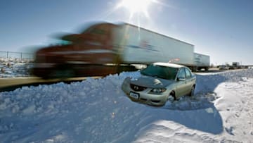 IOWA CITY, IA - FEBRUARY 03: A car sits abandoned in the median of I-380 February 3, 2011 between Cedar Rapids and Iowa City, Iowa. A massive winter storm smashed into a third of the country, from Texas to Wisconsin, on February 1st and 2nd, making travel treacherous. Major highways are now open but a cold snap behind the storm is keeping temperatures hovering around zero degrees in southwest Iowa. (Photo by Chip Somodevilla/Getty Images)