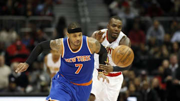 Jan 5, 2016; Atlanta, GA, USA; New York Knicks forward Carmelo Anthony (7) and Atlanta Hawks forward Paul Millsap (4) chase down a loose ball in the fourth quarter of their game at Philips Arena. The Knicks won 107-101. Mandatory Credit: Jason Getz-USA TODAY Sports