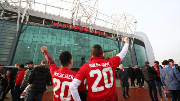 MANCHESTER, ENGLAND - DECEMBER 26: Fans pose for a photo wearing a shirt with the name of Ole Gunnar Solskjaer, Interim Manager of Manchester United as they make their way to the stadium prior to the Premier League match between Manchester United and Huddersfield Town at Old Trafford on December 26, 2018 in Manchester, United Kingdom. (Photo by Clive Brunskill/Getty Images)