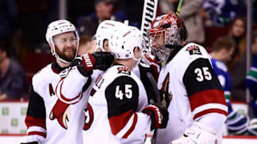 VANCOUVER, BC - FEBRUARY 21: Darcy Kuemper #35 is congratulated by teammates after their overtime win during their NHL game against the Vancouver Canucks at Rogers Arena February 21, 2019 in Vancouver, British Columbia, Canada. (Photo by Jeff Vinnick/NHLI via Getty Images)