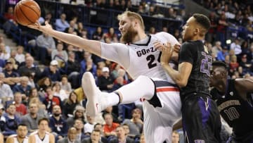 Dec 7, 2016; Spokane, WA, USA; Gonzaga Bulldogs center Przemek Karnowski (24) is fouled while trying to get the rebound against Washington Huskies forward Dominic Green (22) during the second half at McCarthey Athletic Center. The Bulldogs won 98-71. Mandatory Credit: James Snook-USA TODAY Sports