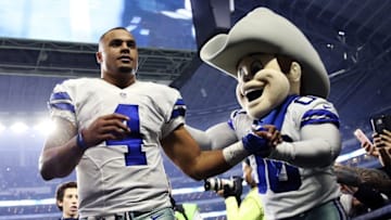 Dec 26, 2016; Arlington, TX, USA; Dallas Cowboys quarterback Dak Prescott (4) celebrates with mascot Rowdy after the game against the Detroit Lions at AT&T Stadium. Mandatory Credit: Kevin Jairaj-USA TODAY Sports
