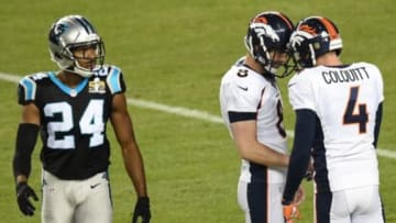 Feb 7, 2016; Santa Clara, CA, USA; Denver Broncos kicker Brandon McManus (8) and punter Britton Colquitt (4) celebrate a kick as Carolina Panthers cornerback Josh Norman (24) looks on during the third quarter in Super Bowl 50 at Levi